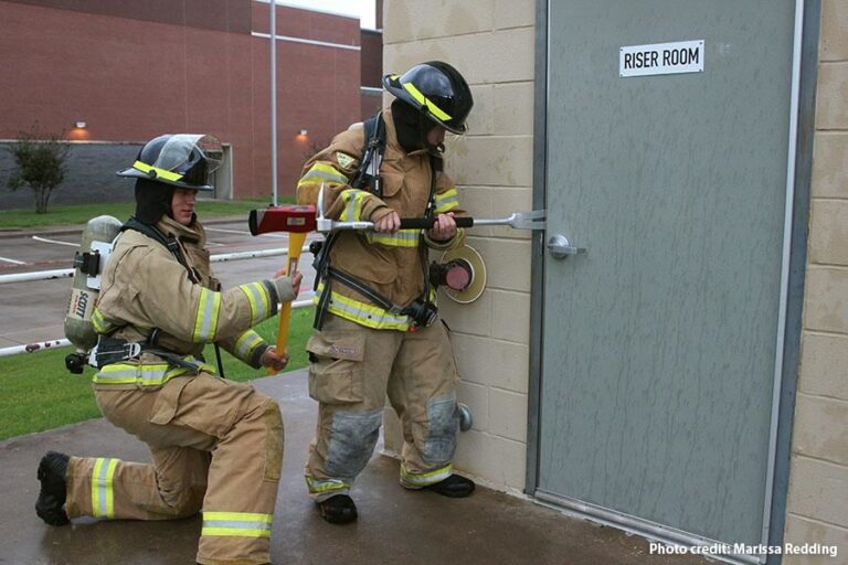 Fire fighters Opening a door fire door inspection
