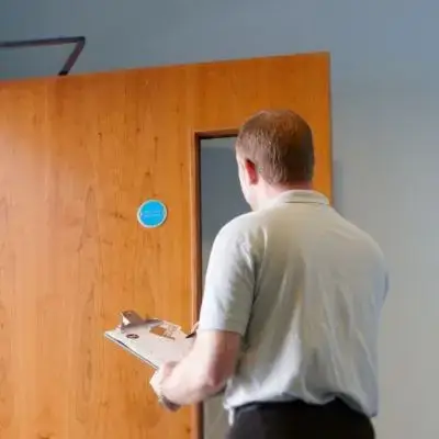 Electrician carrying out an EICR electrical inspection in a North London property