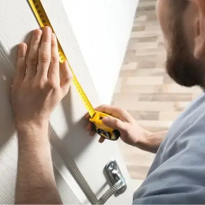 Electrician connecting an electric cooker in a North London kitchen
