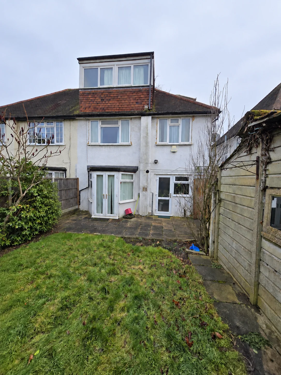 Rear of a house before a rear extension and new garage project in Finchley, NW7 2LJ